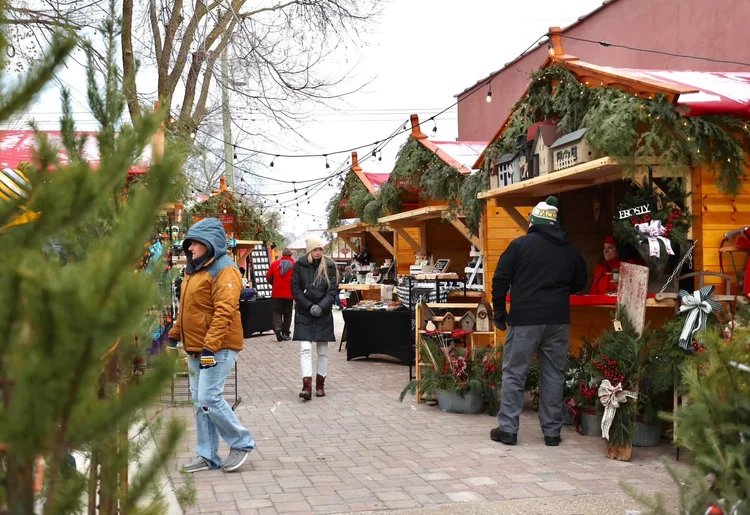 Kriskindlmarkt huts and people in a Christmas setting